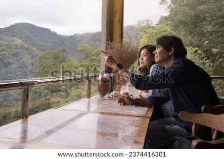 digital nomad concept asian  couple freelancer relax and outdoor work at mountain view of coffeeshop