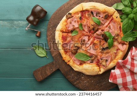 Pizza. Traditional Bacon pizza with ham, mushrooms, pickled cucumber and cheese and cooking ingredients tomatoes basil on wooden table backgrounds. Italian Traditional food. Top view. Mock up. 