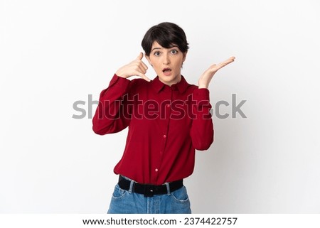 Woman with short hair isolated on white background making phone gesture and doubting