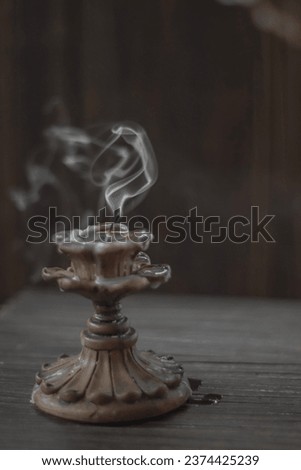 Isolated candle on black with vintage retro candle holder emitting a smoke Royalty-Free Stock Photo #2374425239