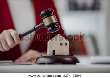 Portrait of young Asian lawyer working and hammer, tablet, laptop in front, justice and legal concept