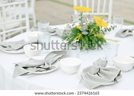 close up white plate, napkin, water goblet and spoon on table, food and drink business, relaxation and lifestyle concept