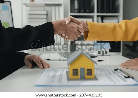 Sales staff discuss home details with customers before agreeing to sign a sales contract, buying and selling real estate, making recommendations and offerings, drafting home sales contracts.