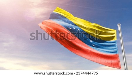 Venezuela national flag waving in beautiful sky. The flag waving with dynamic angle. Royalty-Free Stock Photo #2374444795