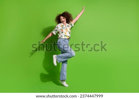 Full length photo of cute excited girl dressed print shirt dancing having fun empty space isolated green color background