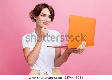 Photo of girl holding wireless computer digital technology touch chin minded on group online conference isolated over pink color background