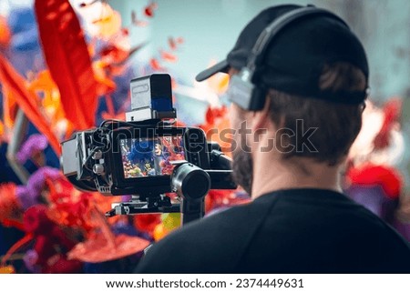 The cameraman films an abstract colorful scene. Film making. Shallow depth of field photo
