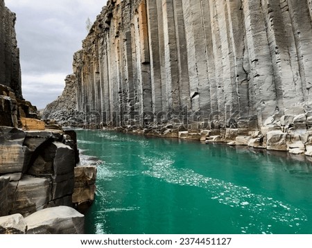 Studlagil basalt canyon, Iceland. One of the most wonderfull nature sightseeing in Iceland. Incredible panoramic view  extraordinary canyon with blue glacial river Royalty-Free Stock Photo #2374451127