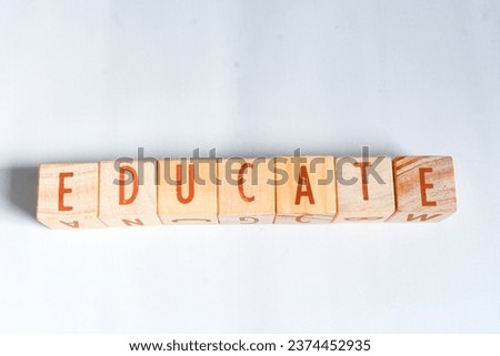 Wooden blocks make up the word "EDUCATE" in English. Wooden block object