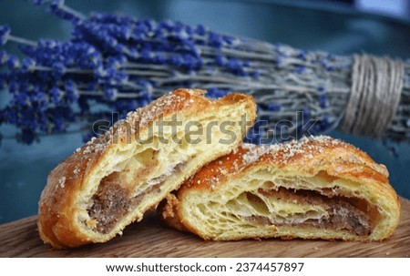Walnut Romanian croissant with fresh lavender flowers background