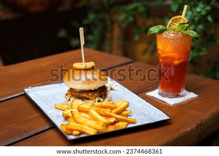 Hamburger with potatoes, onion ring, coleslaw and lemonade