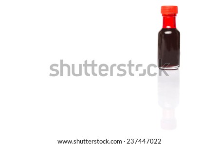 Liquid deep red food color additive over white background