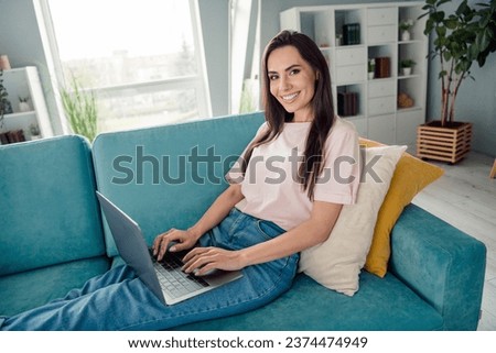 Photo of nice cheerful person sit couch use netbook coworking eshopping modern flat interior indoors