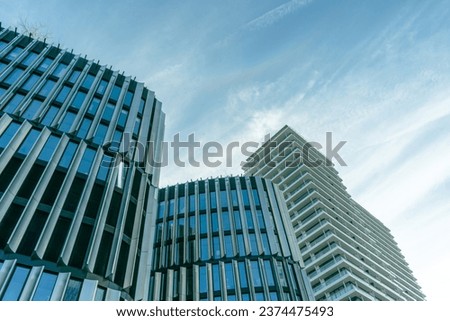 Modern skyscrapers in business district with blue cloudy sky and in perspective view
