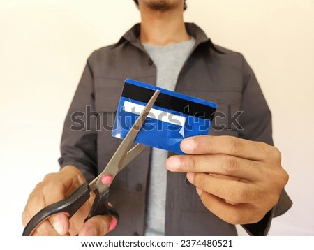 Cut credit card with scissors for stop to pay money protect crisis cost