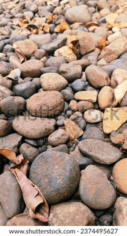 Pebble texture or gravel background for design. Real grunge texture background and small stones. Top view of dirt gravel road.
