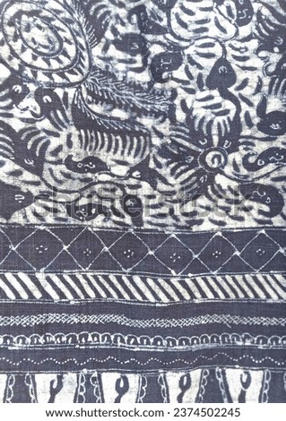 Detailed Batik Tuban, an Indonesian textile art, weaves intricate patterns with wax resist dyeing, celebrating cultural heritage through vibrant textures.
