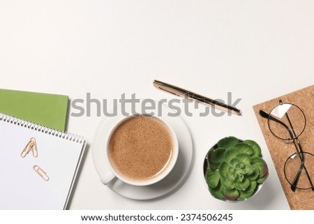 Cup of drink, glasses and different stationery on white desk, flat lay with space for text. Home office