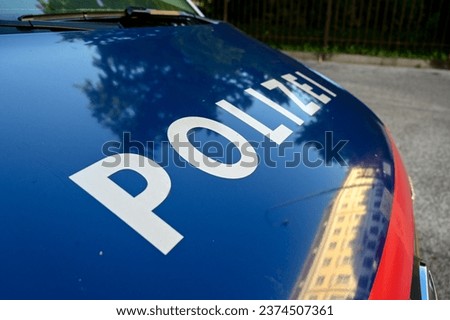 Police patrol car parked on the street in Vienna, Austria. Austrian police van on the street. Front view of a police car with the lettering "Polizei". 