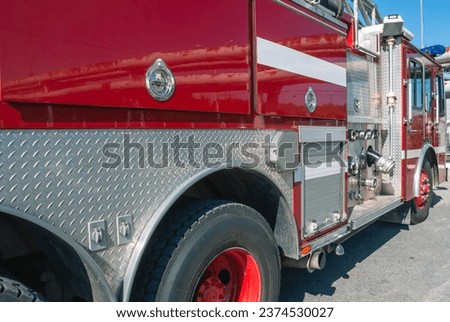 Compartments of a fire truck containing equipment for extinguishing fires and rescuing people. A fire truck for delivering firefighters to the place of fire. The 911 rescue service. Royalty-Free Stock Photo #2374530027