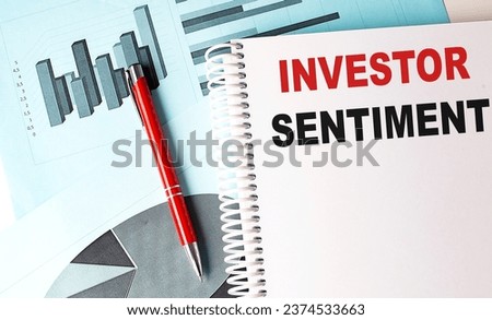 INVESTOR SENTIMENT text on notebook with pen on a chart background Royalty-Free Stock Photo #2374533663