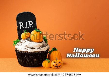 Cupcakes on Halloween. Pumpkin are put on cupcake and besides it. Dessert on Halloween party. Dark background with space. Thanksgiving, October and autumn, for Halloween concept. Happy Halloween,