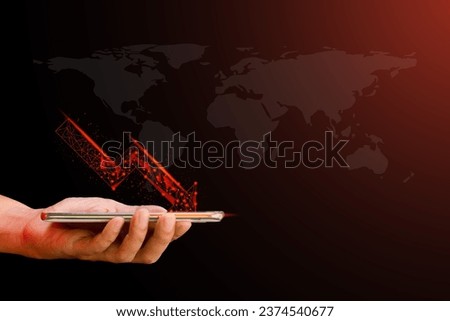 Hand holding mobile or smartphone with red arrow graph drop arrow down with world map on red background. Money losing. Stock crisis and finance concept.