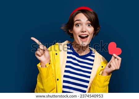 Photo of young girl valentine day enjoy indicate finger empty space with heart amazed buy new car gift isolated on blue color background