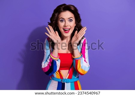 Photo of cheerful lady curly hairdo wear striped clothes raise hands rejoice birthday celebration isolated on purple color background