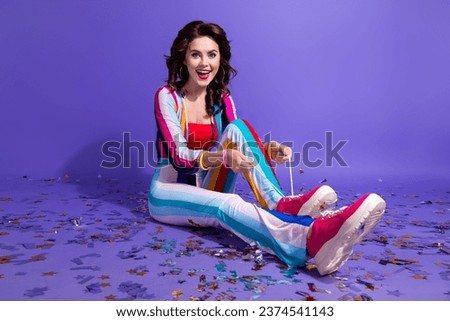 Photo of funky excited lady wear striped overall sitting floor preparing discotheque isolated purple color background