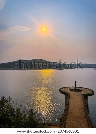 selective focus picture of beautiful sunset near a dam 