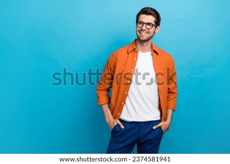 Portrait of cheerful creative minded young person toothy smile look interested empty space isolated on blue color background Royalty-Free Stock Photo #2374581941