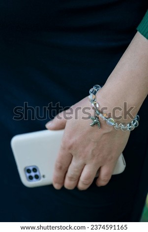 A woman holds a smartphone in her hands. High quality photo