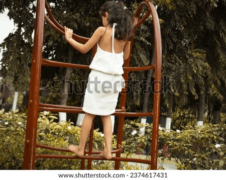 Young little girl best ai editing photo with awesome filter effect. Kid playing in garden on swinging.