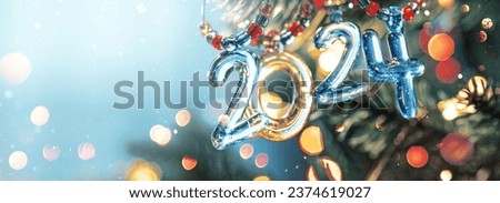 Happy New Year's 2024. Festive background with Christmas lights and snow Royalty-Free Stock Photo #2374619027