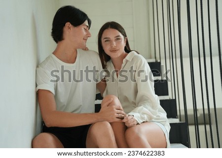 Young happy couple spending their time at home. Young happy couple flirting while enjoying in their time together at home. Lovely young interracial couple dancing at home.