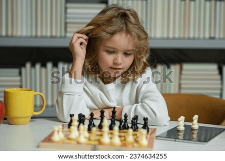 Little child chessman play chess game, checkmate. Royalty-Free Stock Photo #2374634255