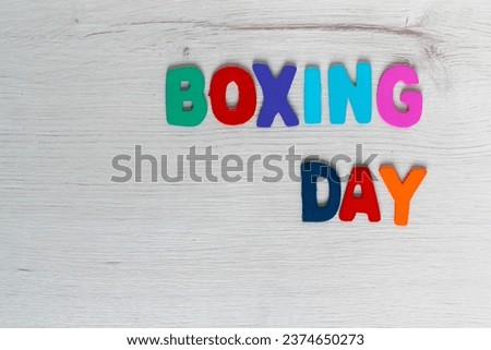 colorful letters with the word boxing day on a light wooden background and space to work

