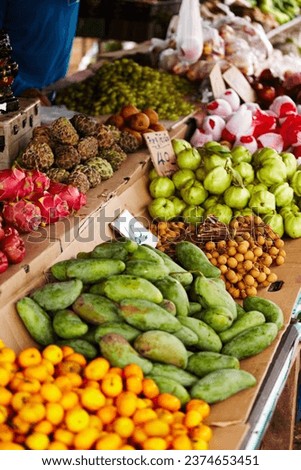 Thailand, fruits and market for natural food, healthy groceries and local vendor with mango, guava and green stock. Seller, supplier or small business with product choice, tourism and sale at store