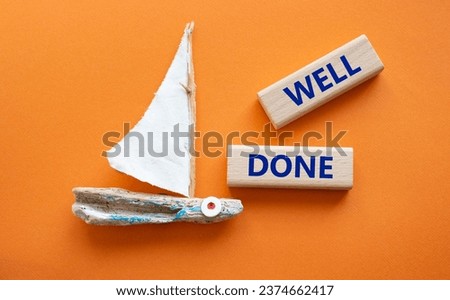 Well done symbol. Wooden blocks with words Well done. Beautiful orange background with boat. Business and Well done concept. Copy space.