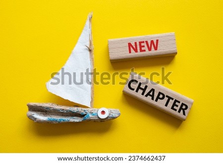 New Chapter symbol. Concept word New Chapter on wooden blocks. Beautiful yellow background with boat. Business and New Chapter concept. Copy space