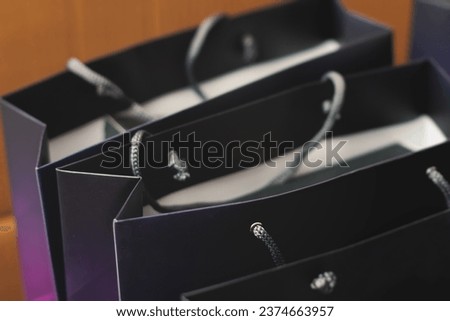 Corporate gifts and souvenirs for company employees, gift bag package for conference participants before start, presentation of corporate gifts, gift giving at office work, dark blue paper bag bunch