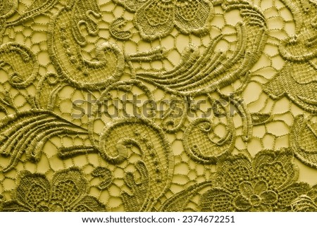 Vintage lace fabric with floral pattern, yellow background with lace pattern. Royalty-Free Stock Photo #2374672251