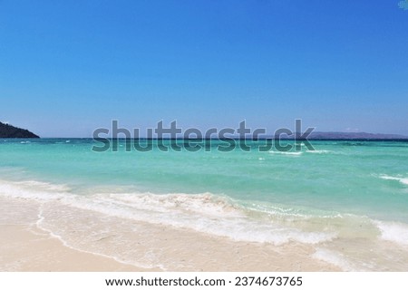 Scenic White Sand Beach with Blue Turquoise Sea Water and Clear Blue Sky During A Hot Summer Day - Pasir Putih Beach in Bajo Pulo Village, Sape, Bima, Indonesia