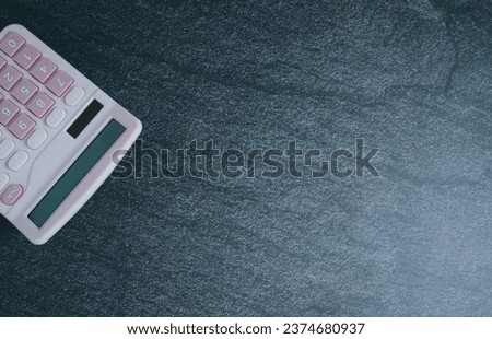 Top view calculator on dark background.