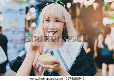 Coconut ice cream in coconut shell in woman hand.