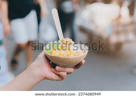 Holding delicious coconut ice cream in hand