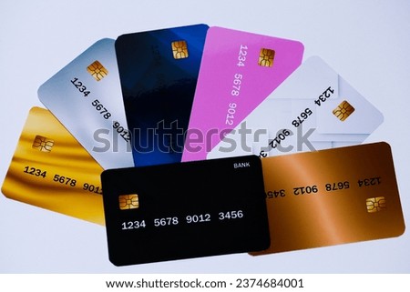 Picture on a gray background with bank cards of different colors that have the meaning of gold, silver, bronze.