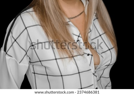 Woman blonde hair in fashion style white blouse with abstract black pattern square lines stripes on dark background.