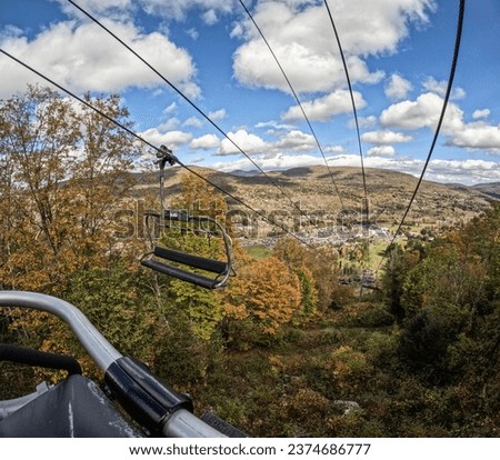 A view of a sky ride in the mountains during fall